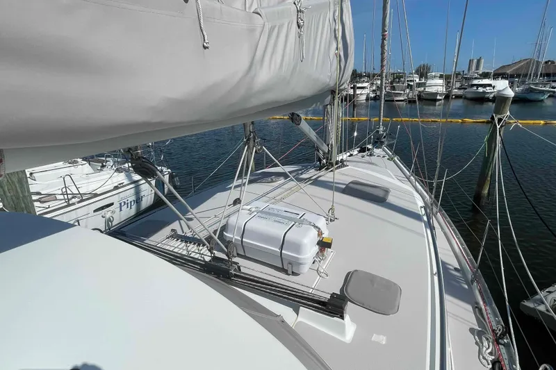 Slide: The Image of 2013 Catalina Morgan 440 sailboat docked at marina, showcasing deck and rigging. - 84