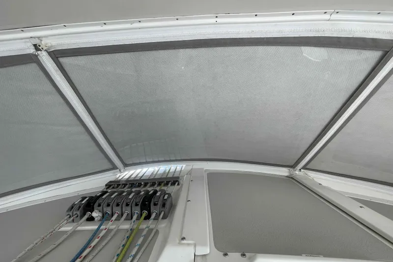 Slide: The Image of Interior view of a 2013 Catalina Morgan 440 sailboat, featuring rigging and mesh canopy. - 86