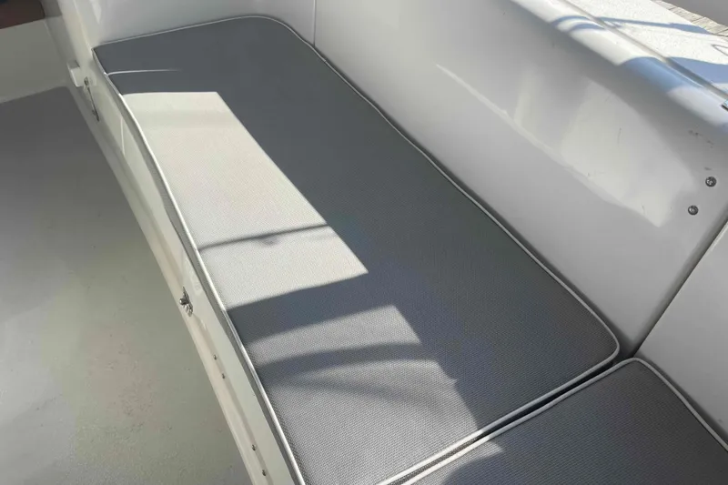 Slide: The Image of Gray cushioned seating on 2013 Catalina Morgan 440 boat, with sunlight casting shadows. - 87
