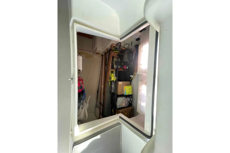 Slide: The Image of Interior view of 2013 Catalina Morgan 440 sailboat storage area with equipment and supplies. - 88