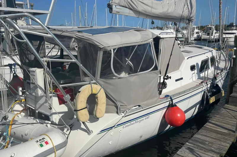 Slide: The Image of Sailboat Catalina Morgan 440, 2013 model, docked at marina with protective canopy. - 93