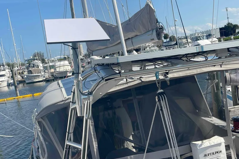 Slide: The Image of Sailboat Catalina Morgan 440, 2013 model, docked at a marina with solar panels. - 94