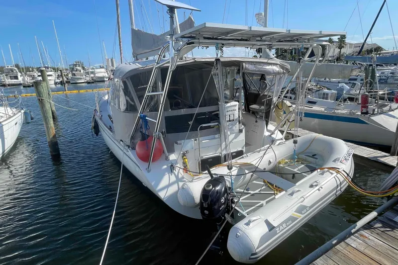 Slide: The Image of 2013 Catalina Morgan 440 sailboat docked with inflatable dinghy attached. - 95
