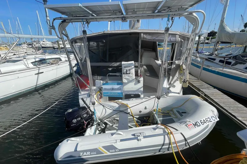 Slide: The Image of Catalina Morgan 440 sailboat, 2013 model, docked with dinghy and solar panels. - 96