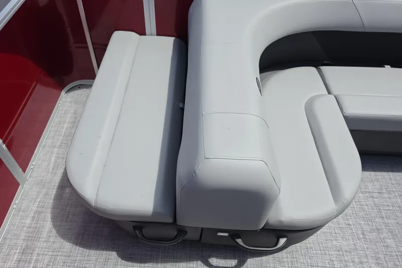 Slide: The Image of 2026 Sun Tracker Party Barge 18 DLX with gray cushioned seating and red paneling. - 11