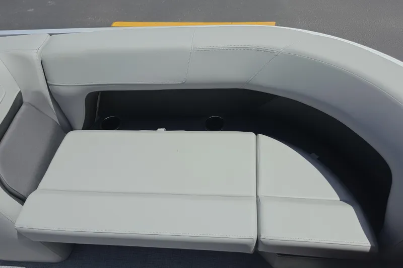 Slide: The Image of 2026 Sun Tracker Party Barge 18 DLX boat seating with cup holders, gray upholstery. - 12