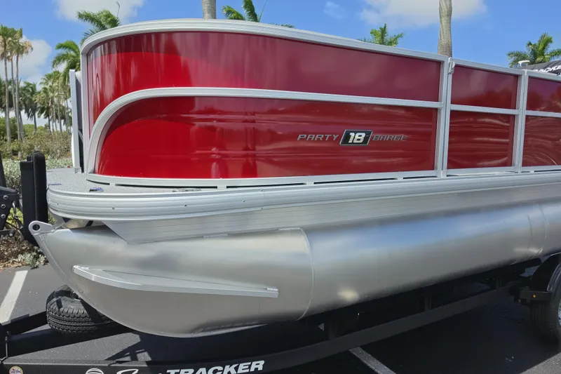 Slide: The Image of 2026 Sun Tracker Party Barge 18 DLX pontoon boat with red and silver design. - 2
