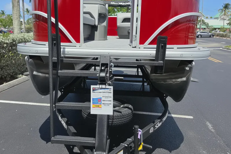Slide: The Image of 2026 Sun Tracker Party Barge 18 DLX pontoon boat on trailer in parking lot. - 3