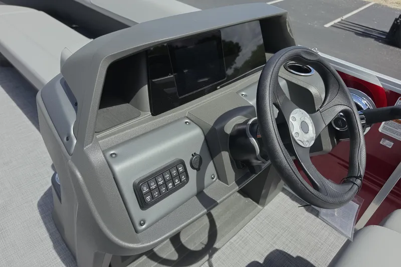Slide: The Image of 2026 Sun Tracker Party Barge 18 DLX dashboard with steering wheel and control panel. - 7