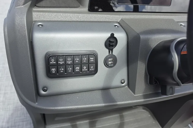 Slide: The Image of Control panel of 2026 Sun Tracker Party Barge 18 DLX with USB ports and switches. - 8
