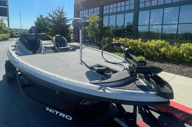 Slide: The Image of 2026 Nitro Z19 XL boat with Minn Kota trolling motor, parked outdoors. - 2
