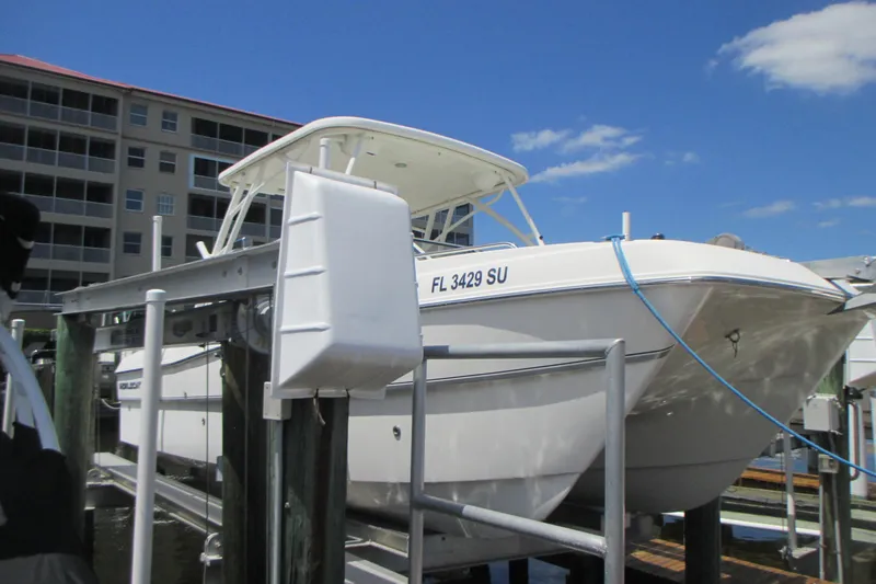 The Image of 2020 World Cat 230 SD boat docked at marina under clear blue sky. - 0