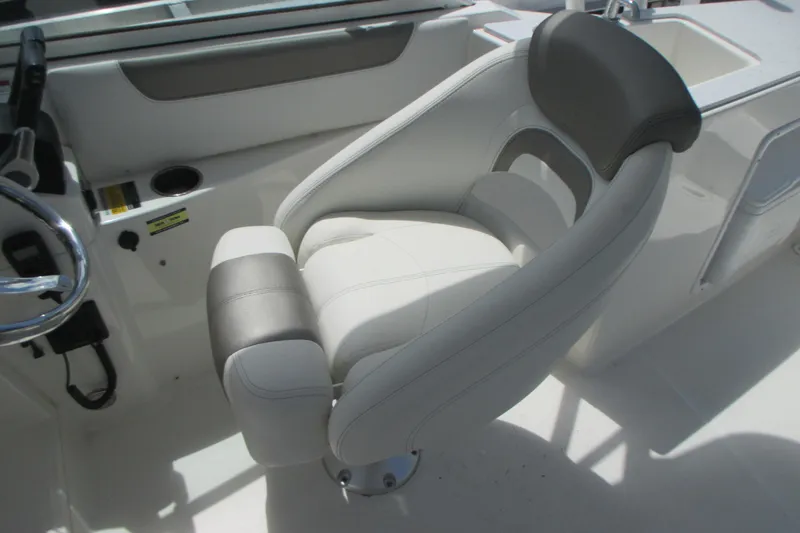 Slide: The Image of 2020 World Cat 230 SD boat interior with seating and helm, docked at marina. - 13