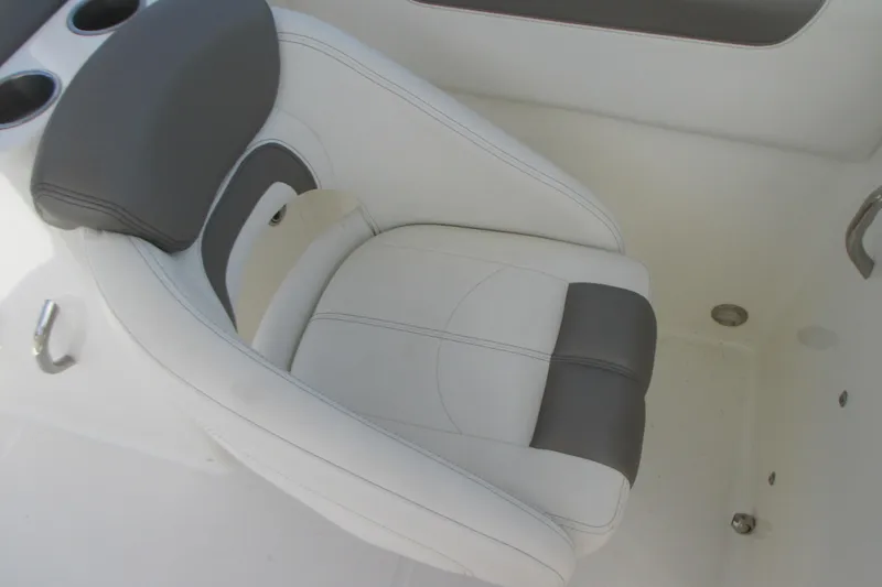 Slide: The Image of Interior view of a 2020 World Cat 230 SD boat with cushioned seating and covered engines. - 14