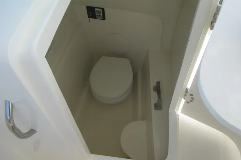 Slide: The Image of 2020 World Cat 230 SD boat interior with compact marine toilet. - 21