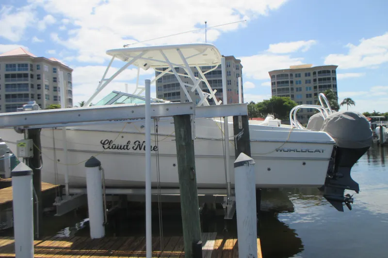 Slide: The Image of 2020 World Cat 230 SD boat docked at marina with buildings in background. - 4