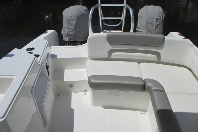 Slide: The Image of 2020 World Cat 230 SD boat docked, covered with a protective tarp. - 8