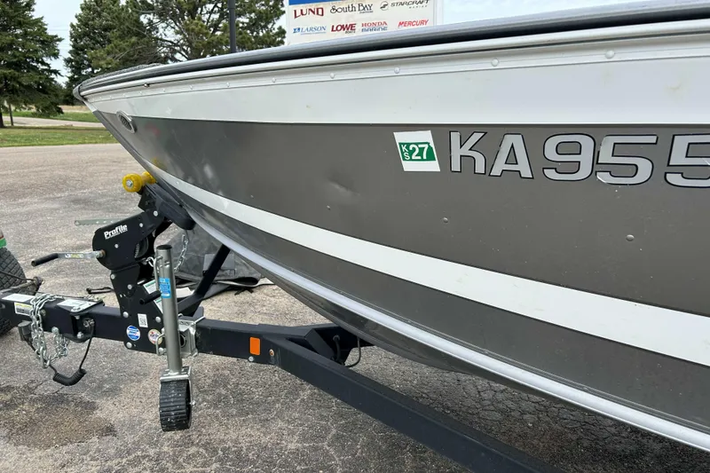 Slide: The Image of 2025 Lund 1875 Impact XS Sport boat on trailer, registration KA9555, parked outdoors. - 4