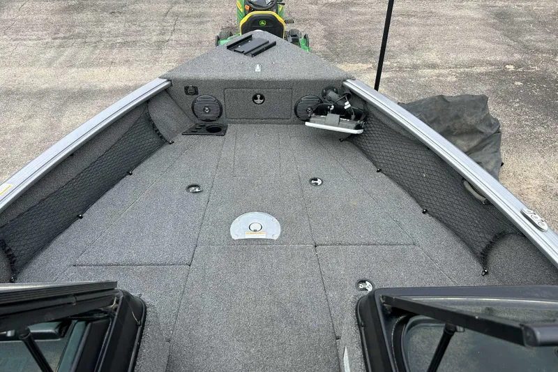 Slide: The Image of 2025 Lund 1875 Impact XS Sport boat deck with storage compartments and fishing gear. - 5