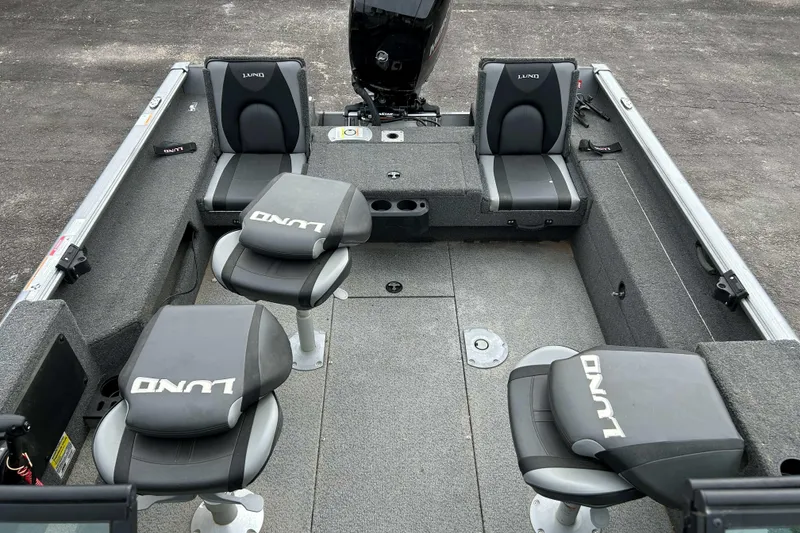 Slide: The Image of 2025 Lund 1875 Impact XS Sport boat interior with four seats and motor. - 6