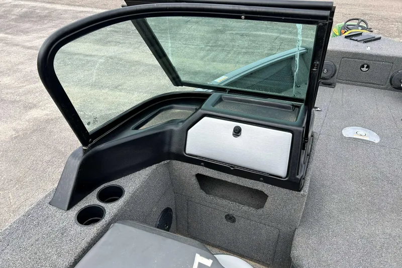 Slide: The Image of 2025 Lund 1875 Impact XS Sport boat interior with windshield and storage compartment. - 8