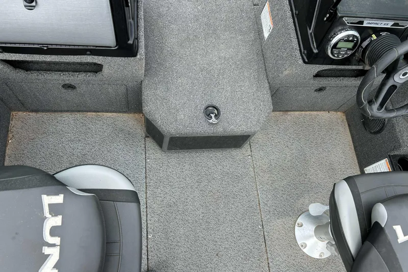 Slide: The Image of Interior of 2025 Lund 1875 Impact XS Sport boat with carpeted flooring and seating. - 9