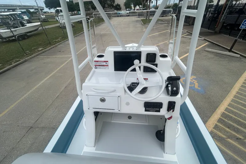 Slide: The Image of 2026 Shallow Sport 22 Sport boat console with steering wheel and controls. - 12