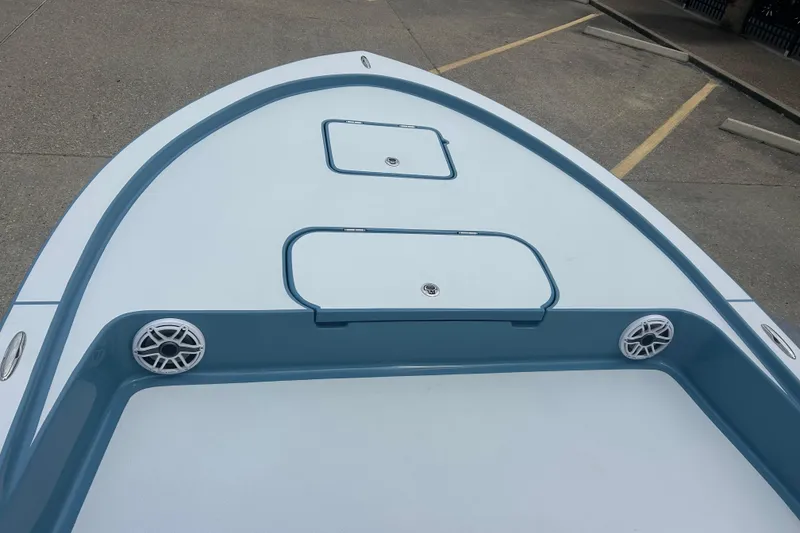 Slide: The Image of Bow view of 2026 Shallow Sport 22 Sport boat with storage hatches and speakers. - 5