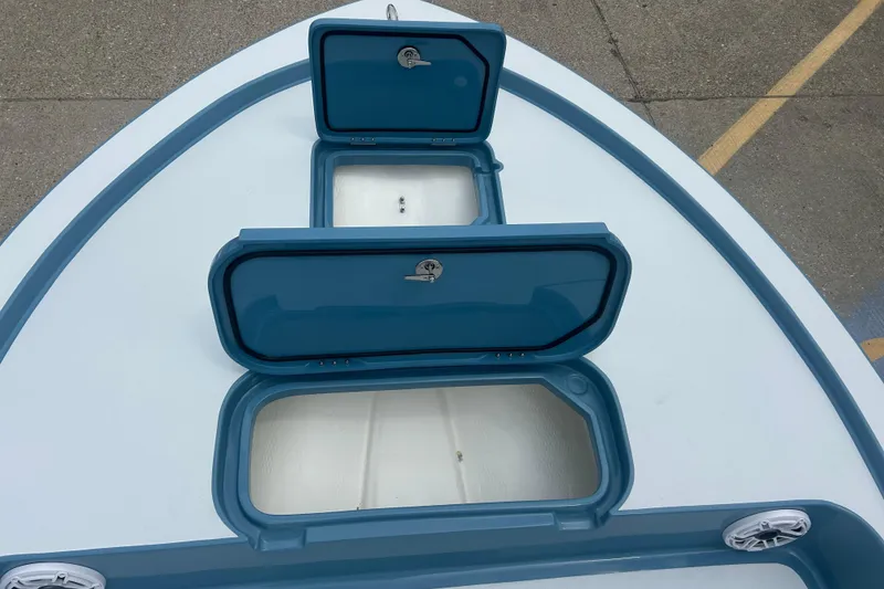 Slide: The Image of 2026 Shallow Sport 22 Sport boat deck with open storage compartments. - 6