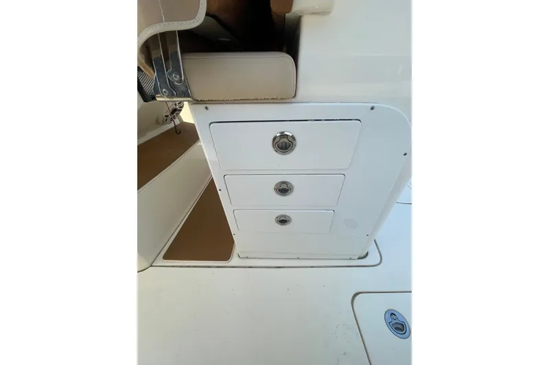 Slide: The Image of 2023 Scout 305 LXF boat interior storage drawers with sleek design and secure latches. - 20