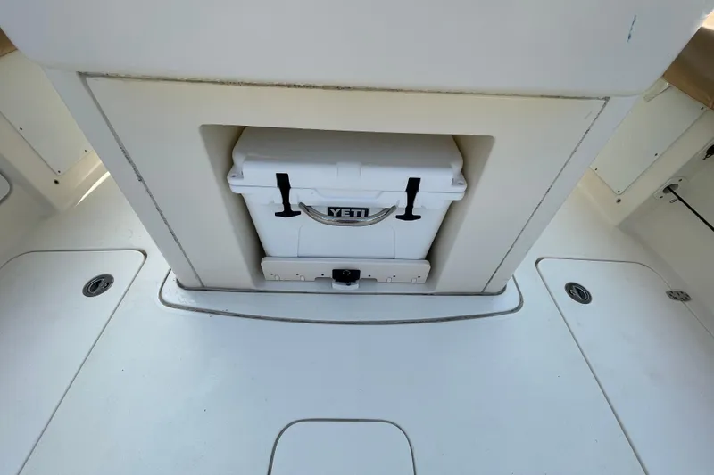 Slide: The Image of 2023 Scout 305 LXF boat interior with Yeti cooler storage compartment. - 22