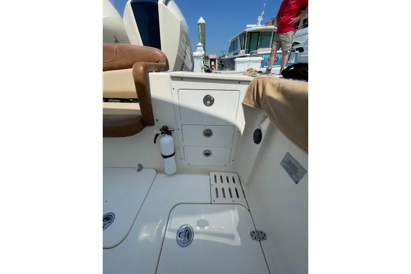 Slide: The Image of 2023 Scout 305 LXF boat interior with storage drawers and seating. - 23