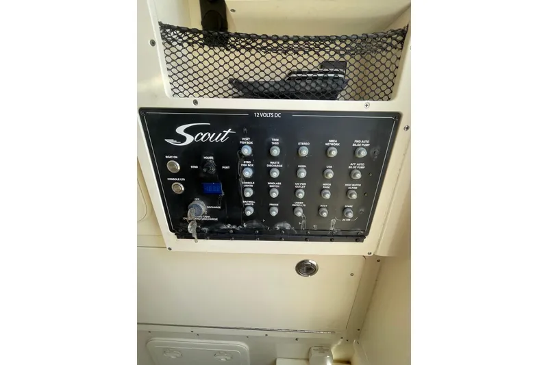 Slide: The Image of Control panel of 2023 Scout 305 LXF boat with various switches and indicators. - 28