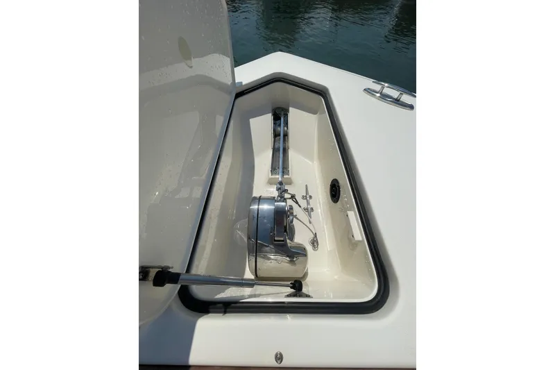 Slide: The Image of 2023 Scout 305 LXF boat anchor compartment with stainless steel fittings. - 8