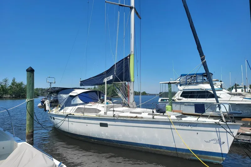 The Image of Sailboat Hunter Legend 40.5, 1993 model, docked at a marina under clear blue skies. - 0