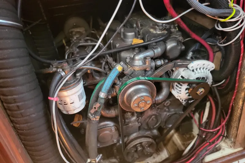 Slide: The Image of Engine compartment of a 1993 Hunter Legend 40.5 sailboat, showing detailed mechanical components. - 11
