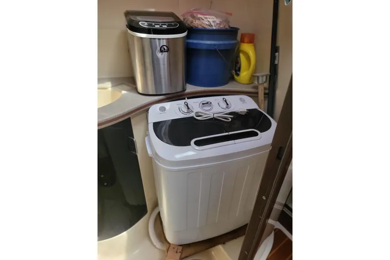 Slide: The Image of Compact laundry setup in a 1993 Hunter Legend 40.5 yacht interior. - 12