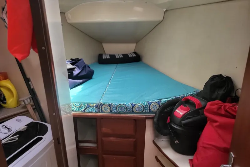 Slide: The Image of Cozy cabin interior of 1993 Hunter Legend 40.5 sailboat with storage and bedding. - 13