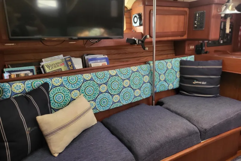 Slide: The Image of Cozy interior of 1993 Hunter Legend 40.5 sailboat with patterned cushions and nautical decor. - 14