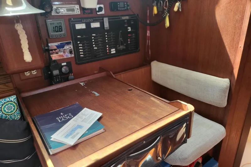 Slide: The Image of Navigation station of a 1993 Hunter Legend 40.5 sailboat with ship's log. - 15