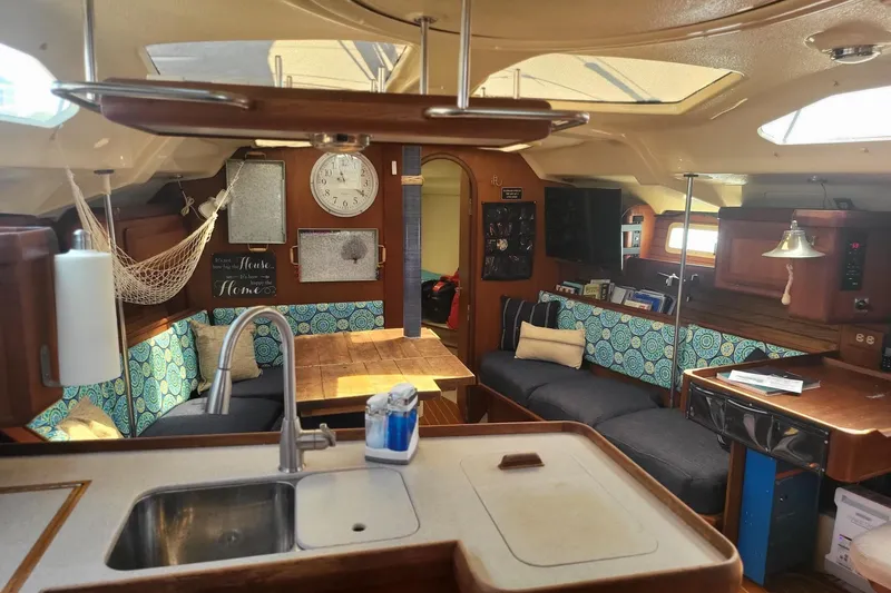 Slide: The Image of Interior of 1993 Hunter Legend 40.5 yacht with cozy seating and wooden finishes. - 16