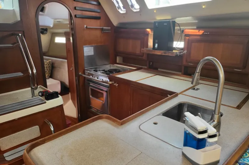 Slide: The Image of Interior of 1993 Hunter Legend 40.5 yacht with kitchen and seating area. - 18