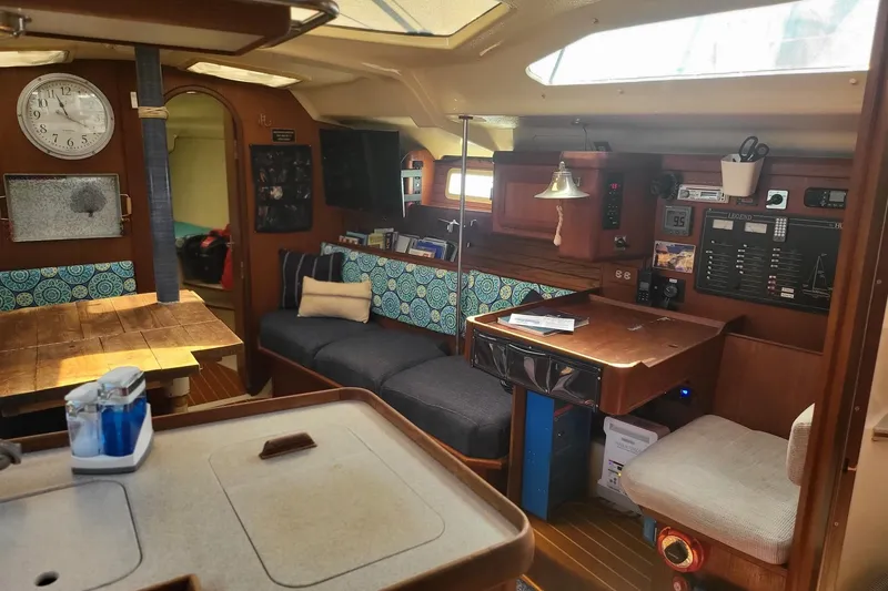 Slide: The Image of Interior of a 1993 Hunter Legend 40.5 sailboat with cozy seating and navigation area. - 2
