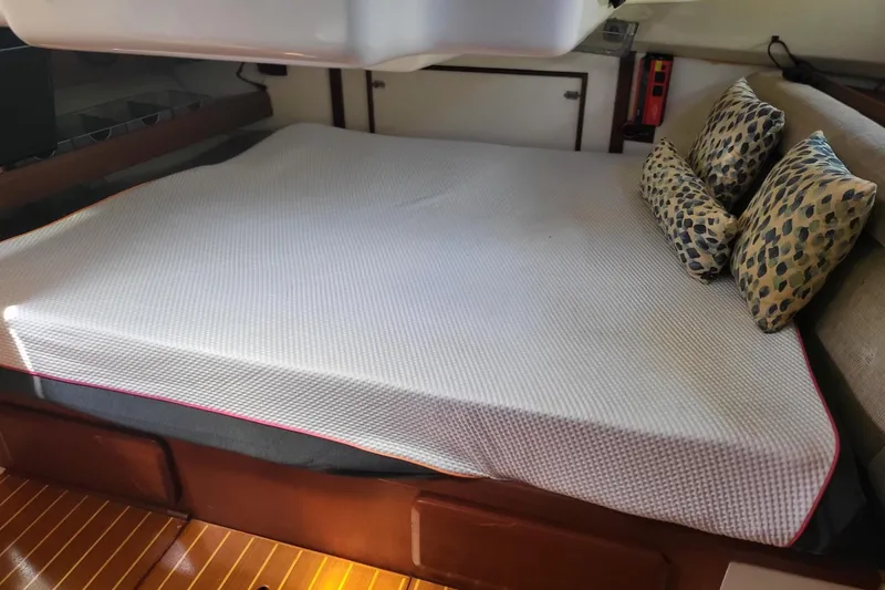 Slide: The Image of Interior cabin of 1993 Hunter Legend 40.5 sailboat with bed and patterned pillows. - 20