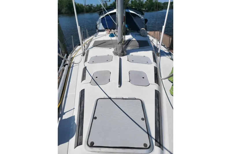Slide: The Image of Hunter Legend 40.5 sailboat deck, 1993 model, docked by a calm river. - 22