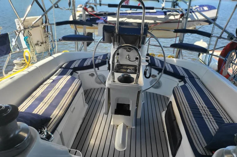 Slide: The Image of Cockpit of 1993 Hunter Legend 40.5 sailboat with striped seating and steering wheel. - 3