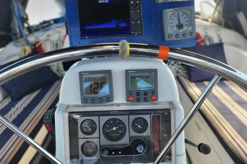 Slide: The Image of Cockpit of 1993 Hunter Legend 40.5 sailboat with navigation instruments and steering wheel. - 5