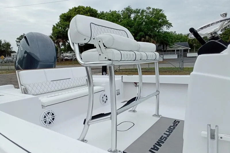 Slide: The Image of 2021 Sportsman Masters 207 Bay Boat interior with white seating and sleek design. - 10