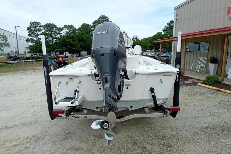 Slide: The Image of 2021 Sportsman Masters 207 Bay Boat with Yamaha 150 engine on trailer. - 16