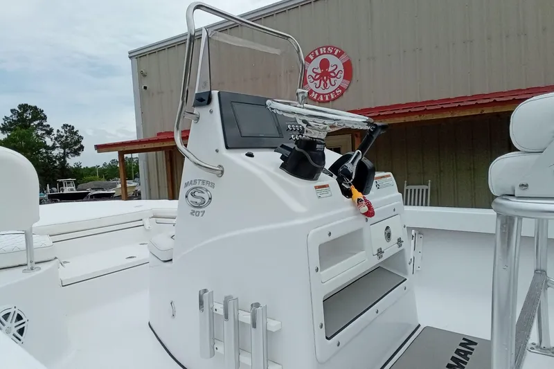 Slide: The Image of 2021 Sportsman Masters 207 Bay Boat console with steering wheel and controls. - 19